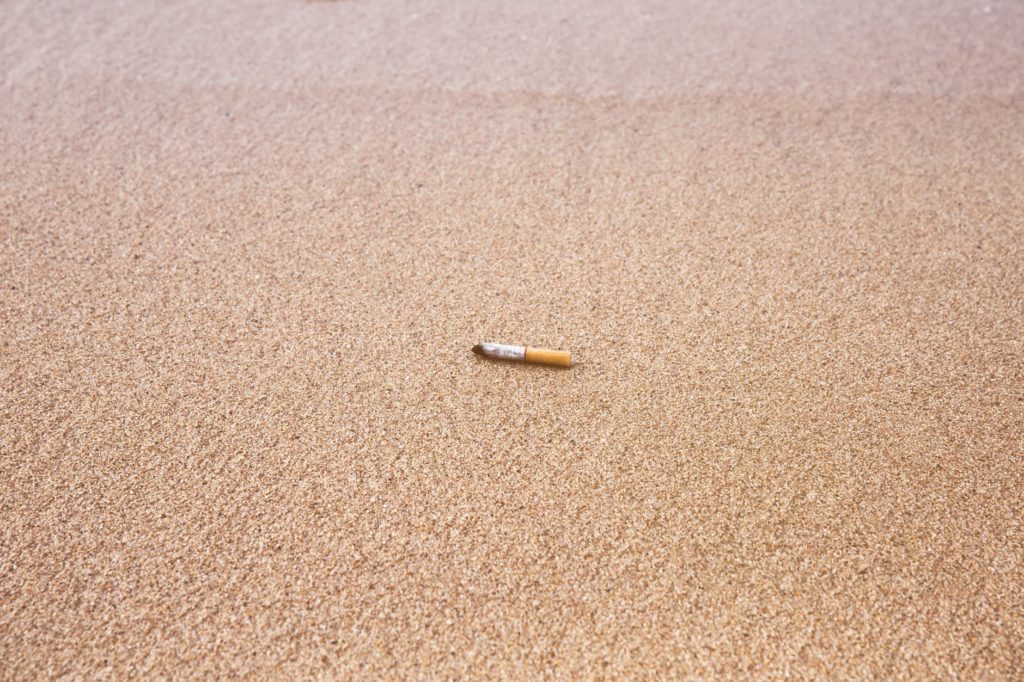 cigarette stick on sand